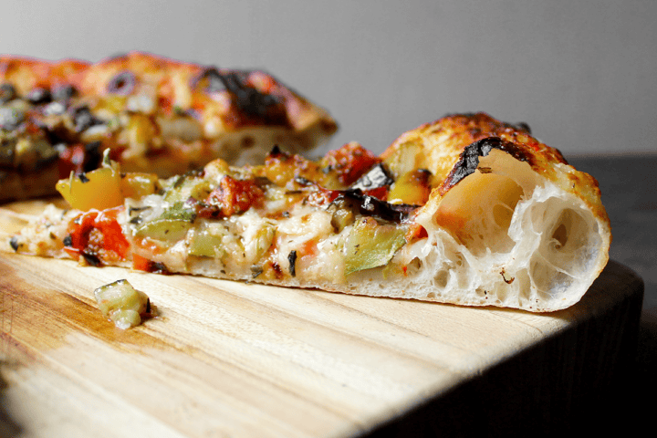 Ratatouille Pizza slice, side view of crust
