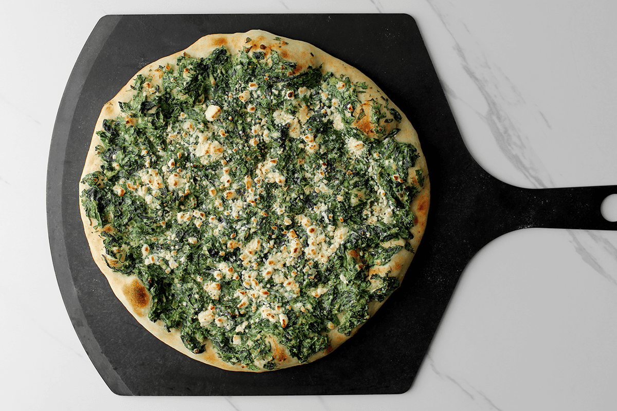 spanakopita pizza finished on peel