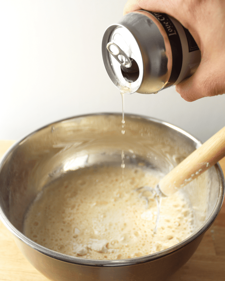 pouring beer into bowl with other ingredients