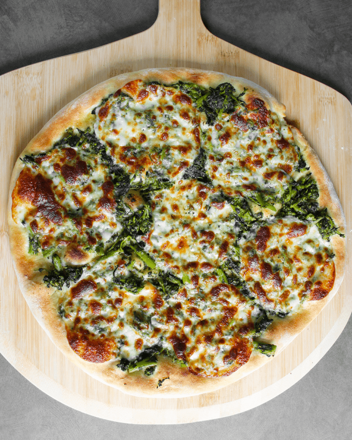 broccoli rabe chimichurri pizza on peel