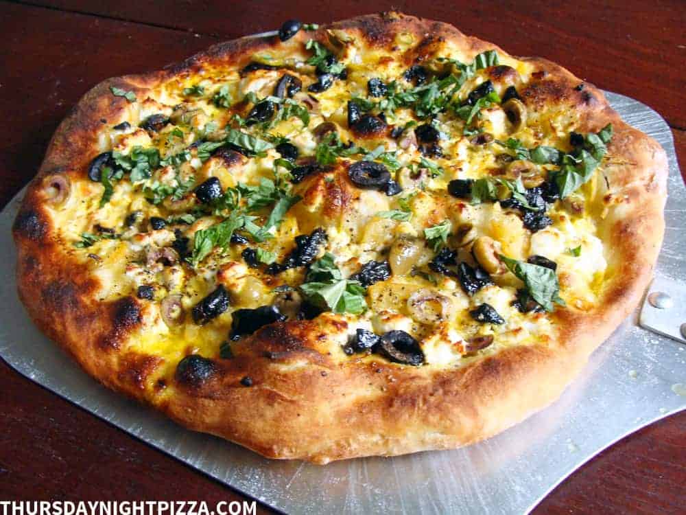 Moroccan-Inspired Pizza with Preserved Lemon, Olives, and Saffron Cream