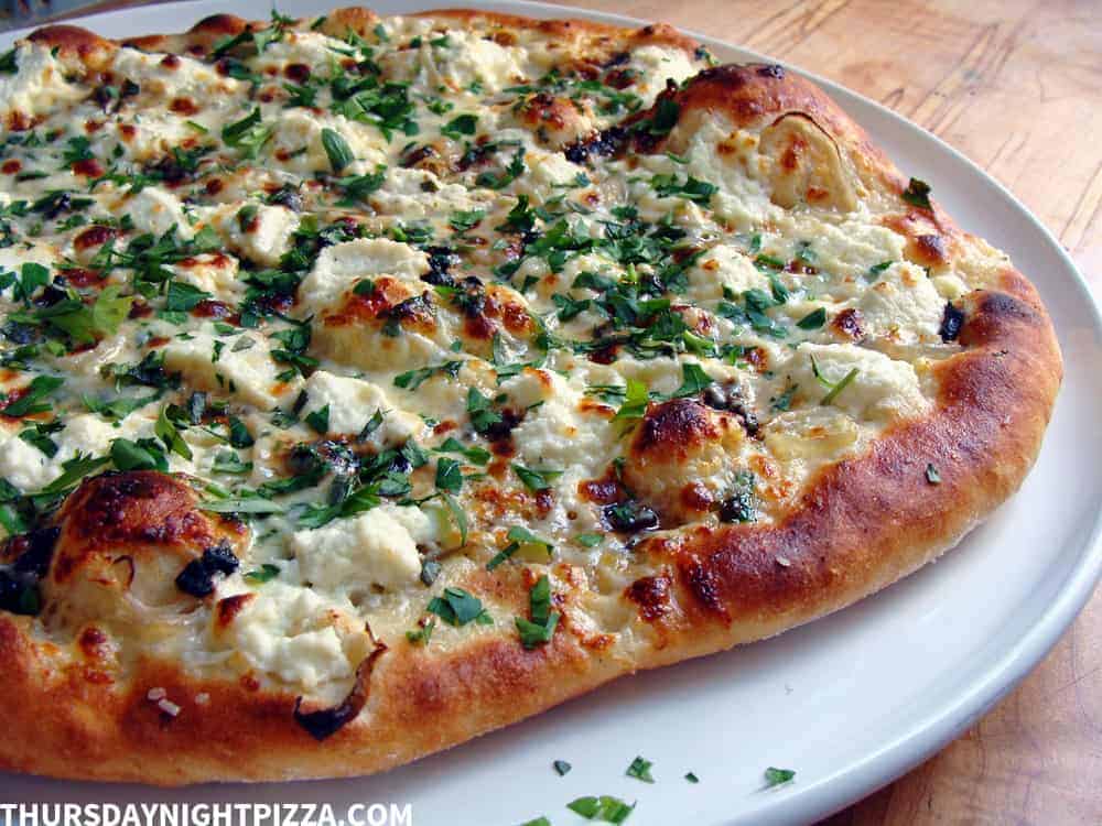 https://www.thursdaynightpizza.com/wp-content/uploads/2018/03/black-garlic-ricotta_side-uncut_stamp-1.jpg