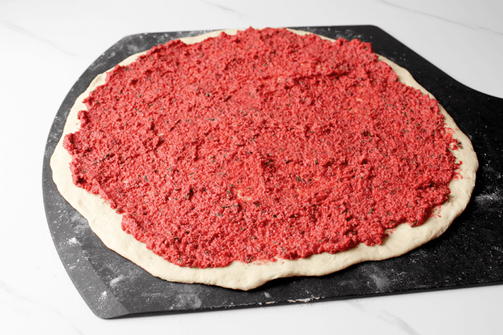 beet pesto sauce on dough