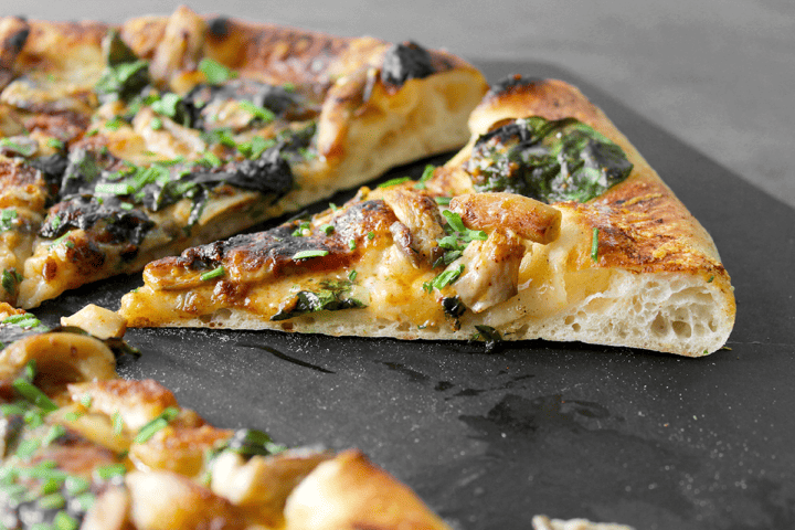 oyster mushroom pizza with paprika, spinach, parmesan, and cream