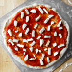 Neapolitan pizza dough topped on pizza peel