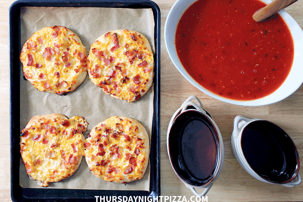 Personal pizzas and tomato soup, ready for serving