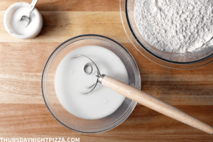 Mixing the starter, water, and salt