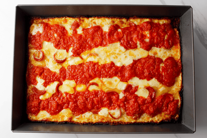 Detroit style pepperoni pizza in pan after baking
