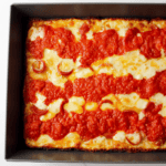 Detroit style pepperoni pizza after baking in pan