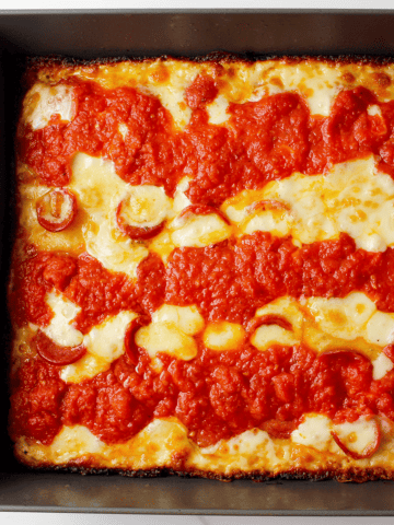 Detroit style pepperoni pizza after baking in pan