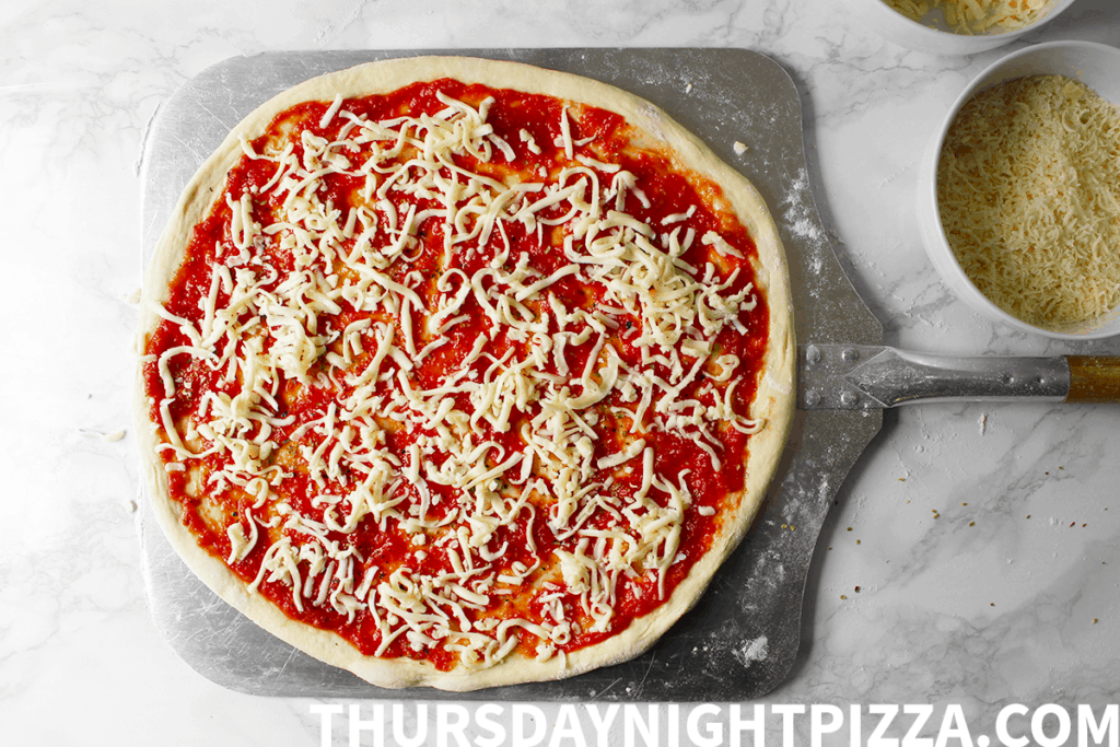 dough stretched and topped