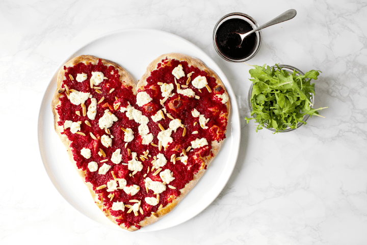 heart-shaped pizza with toppings