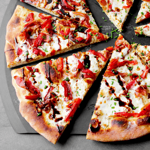prosciutto pizza slices on peel