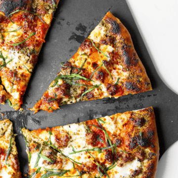 Italian sausage pizza with pesto and marinara sauce