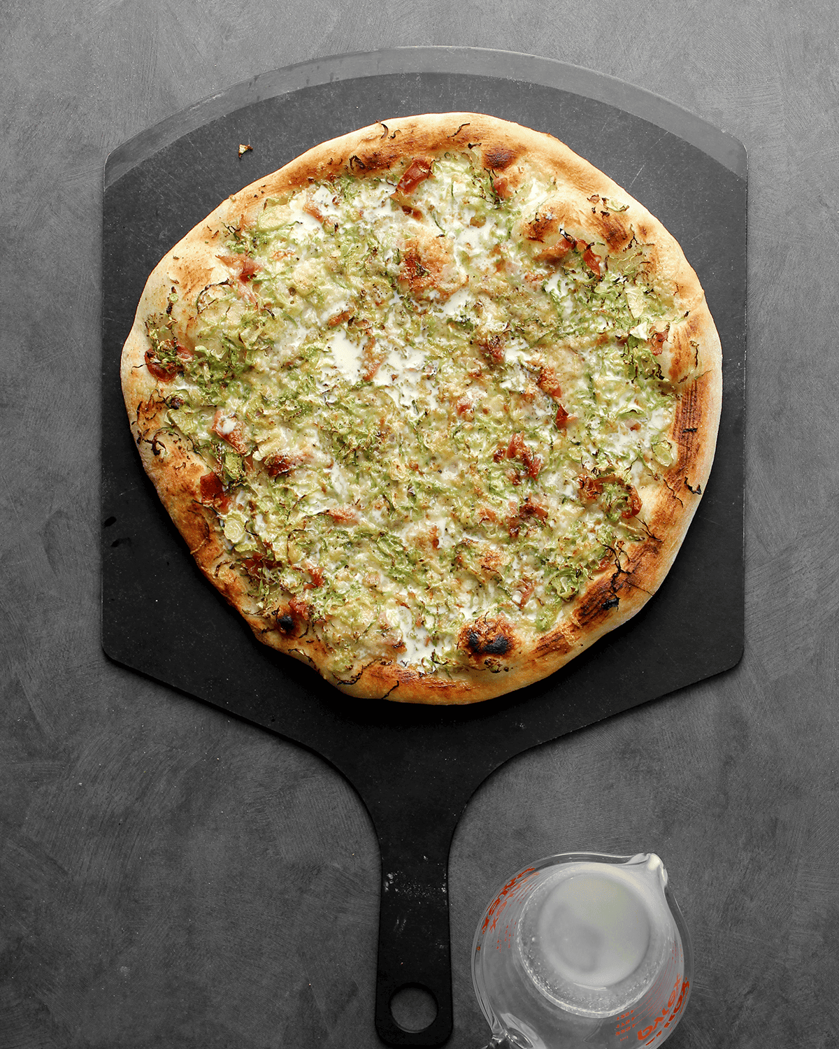 Brussels sprout and prosciutto pizza with mustard and gruyere