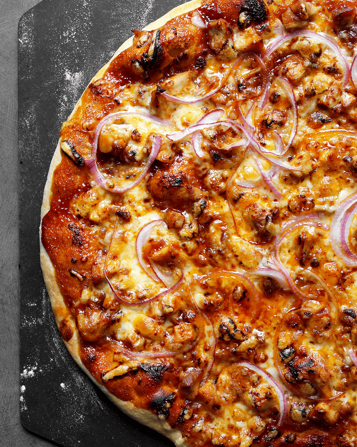 bbq chicken pizza on pizza peel fresh from the oven